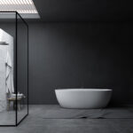 Interior of stylish bathroom with gray and white walls, concrete floor, shower stall with glass walls, white bathtub and table with towels and bottles. 3d rendering